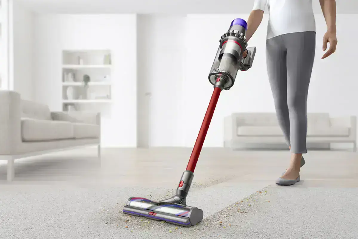 жінка пилососить килим dyson outsize vacuum